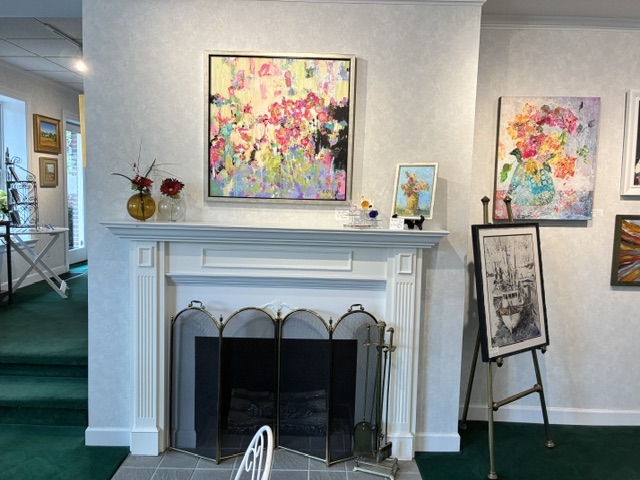 Original paintings hung above the fireplace inside Frame House Gallery