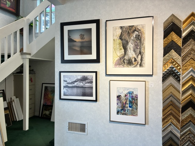 Frame moulding samples beside framed artwork at Frame House Gallery