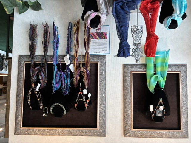 Scarves, necklaces and earrings displayed in the Frame House gift shop